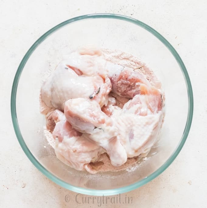 coating brined chicken pieces in the flour mix.