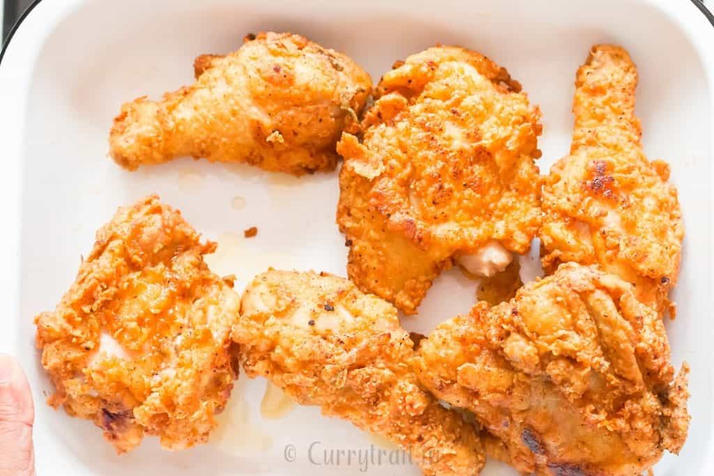 crispy fried chicken placed on a white tray.