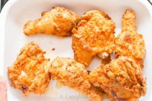 ultimate ultra crispy and moist Southern fried chicken with lemon wedges