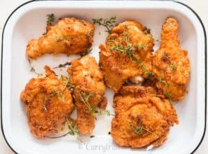 ultimate ultra crispy and moist Southern fried chicken with lemon wedges