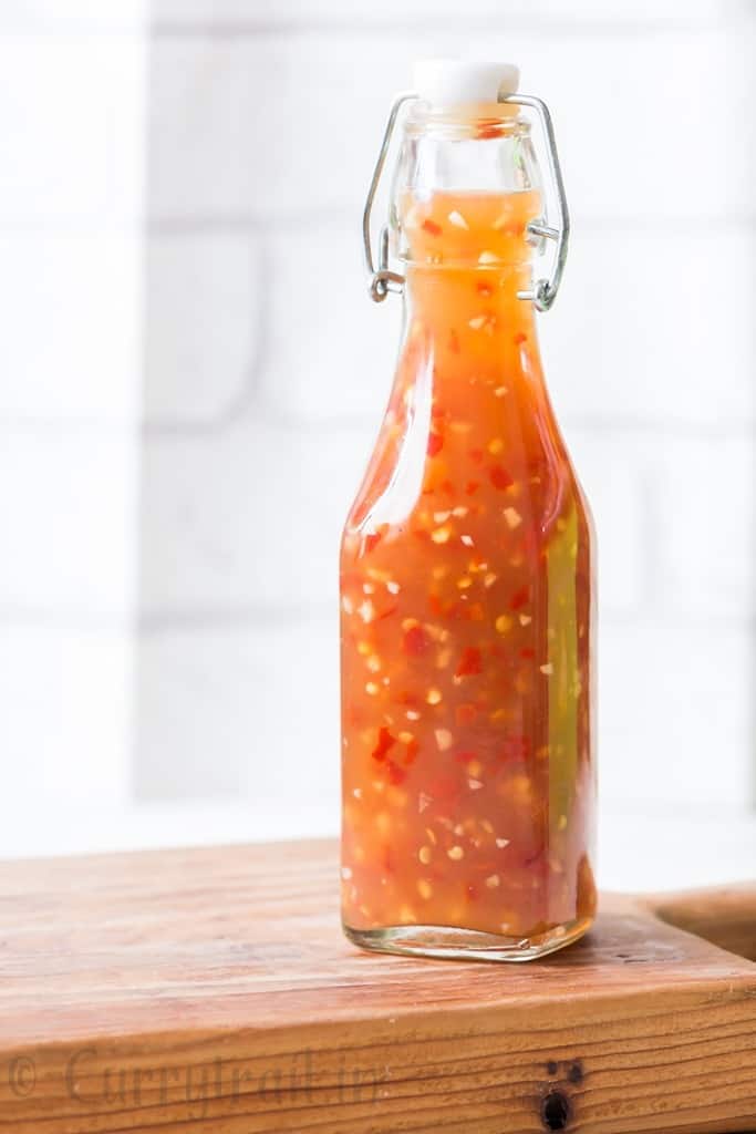 homemade spicy sweet chili sauce in glass bottle