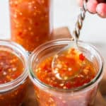 homemade spicy sweet chili sauce in 3 glass containers with text overlay