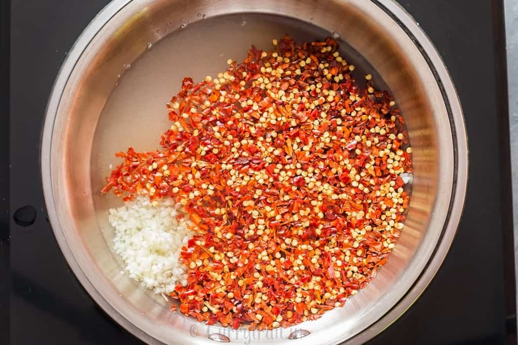 cooking homemade spicy sweet chili sauce in pan