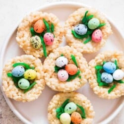 Easter Rice Krispie Treats Birds Nests topped with colored coconut flakes and Easter eggs