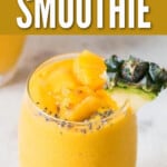 close up view of pineapple smoothie with pineapple wedge.