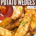oven baked garlic parmesan baked potato wedges with ketchup with text