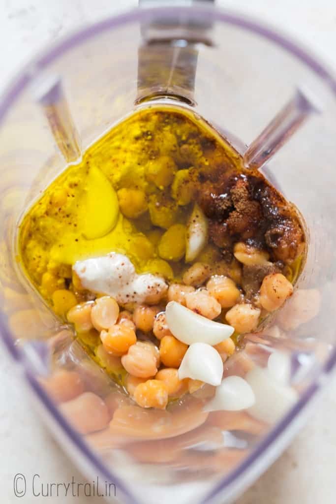 chickpeas, olive oil, garlic, tahini, paprika, cumin, salt and pepper in blender jar