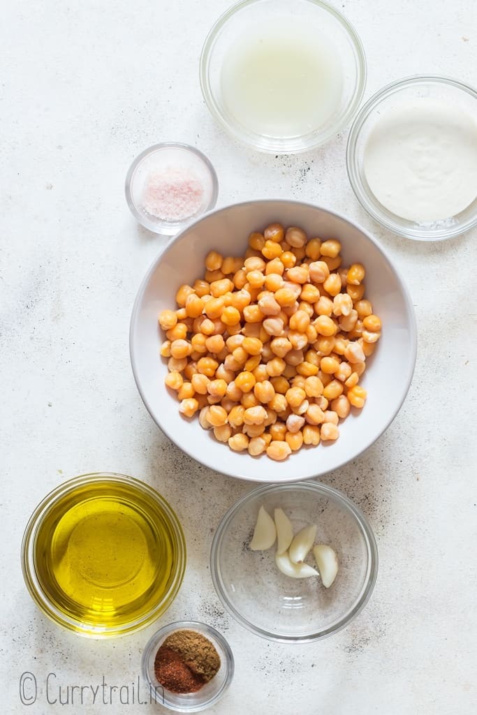 all ingredients to make hummus recipe on white board