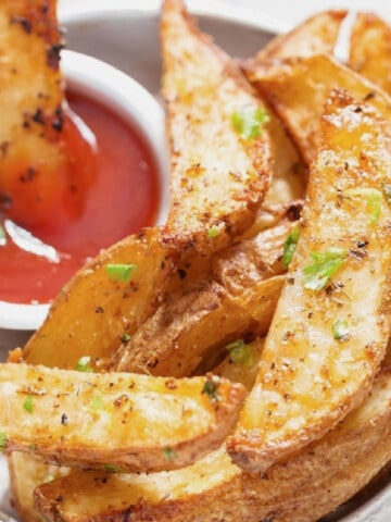 close-up view of potato wedges with ketchup.