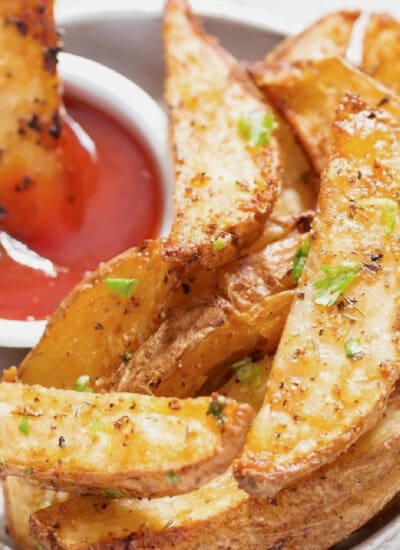 close-up view of potato wedges with ketchup.