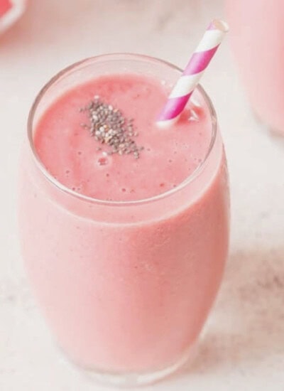 watermelon smoothie with chia seeds sprinkled on top.