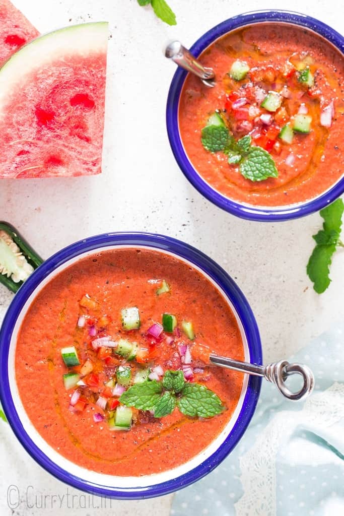 cold summer watermelon gazpacho served in two white bowls