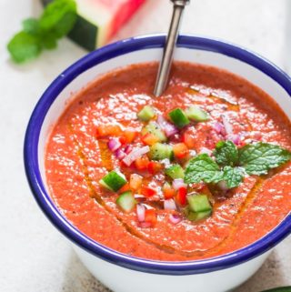 healthy cold watermelon gazpacho soup served in white bowl