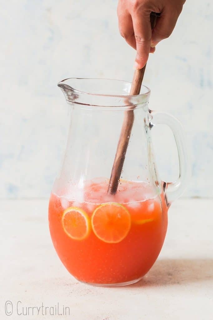 healthy strawberry lemonade recipe stirred in big glass pitcher