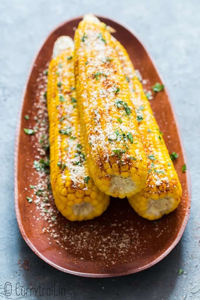 best juicy instant pot corn on cob sprinkled with chili lime and Parmesan