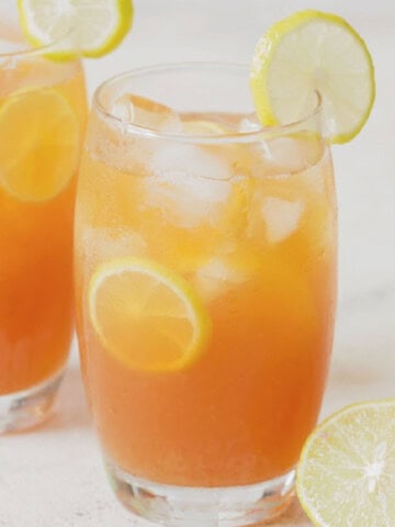 iced tea with lemon and honey served in two glasses.