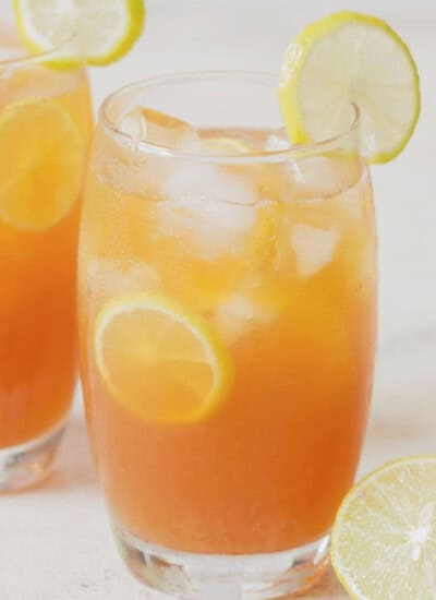 iced tea with lemon and honey served in two glasses.