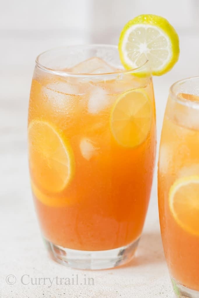 refreshing lemon iced tea served with ice cubes and lemon slices