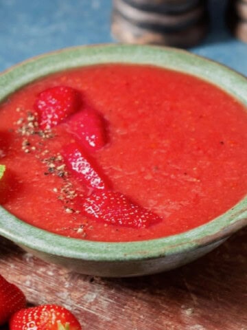 a bowl of chilled gazpacho made of strawberries.