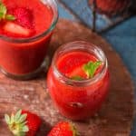 healthy cold summer strawberry gazpacho soup served in glass jars