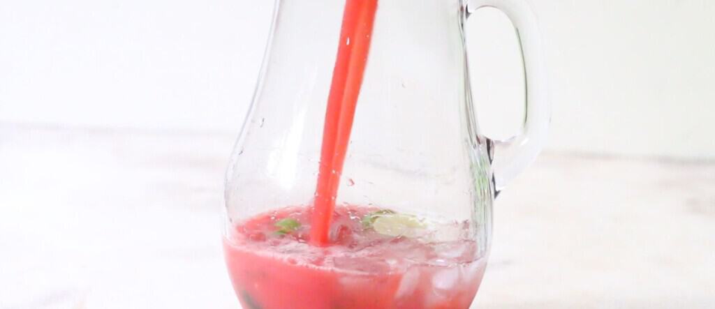 pour watermelon juice into a pitcher to make mojito.