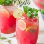 fresh watermelon mojito in glass with fresh mint and lime slices.