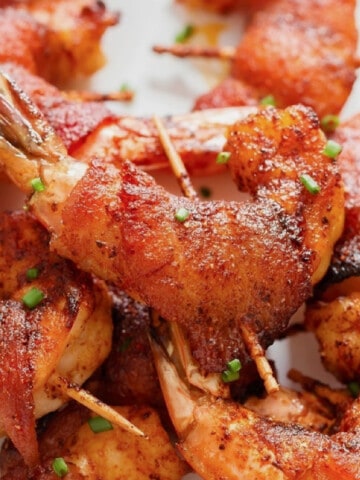 close-up view of bacon-wrapped shrimp on a plate.