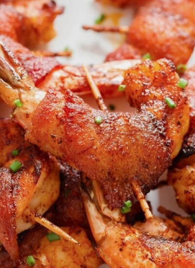 close-up view of bacon-wrapped shrimp on a plate.