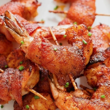 close-up view of bacon-wrapped shrimp on a plate.