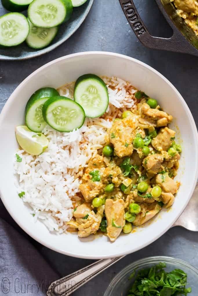 a bowl of rice and coconut curry chicken poured on top