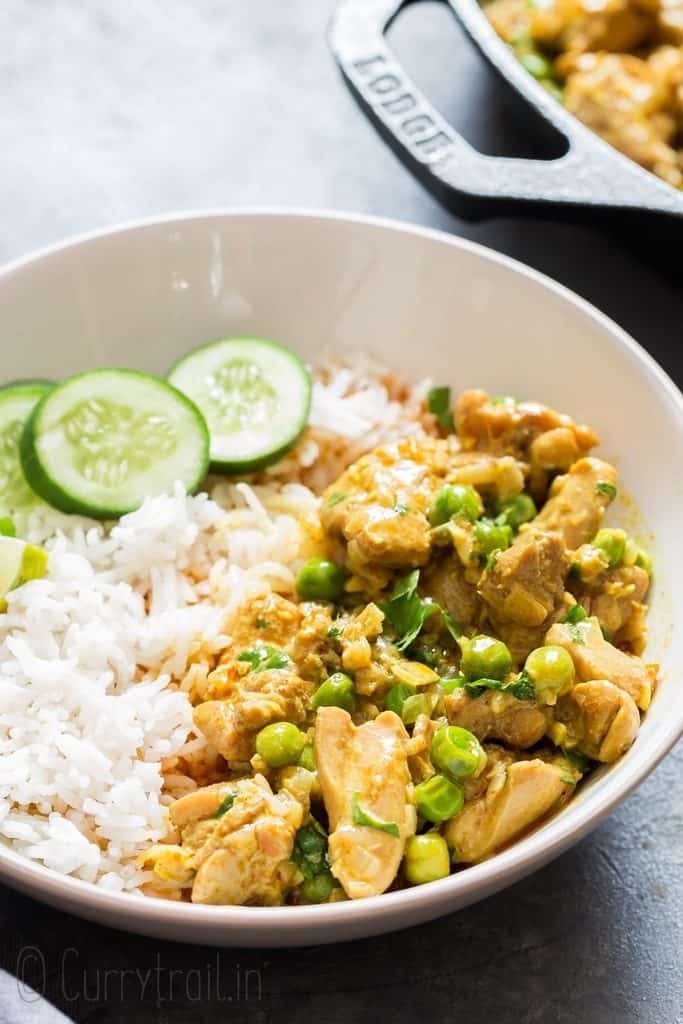 chicken curry served over rice in white bowl