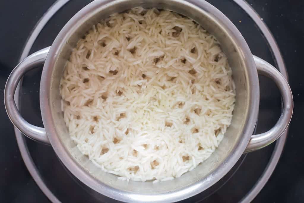 rice simmering in stock in a deep-bottomed pan.