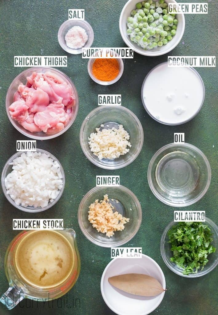 ingredients for chicken curry recipe on green board