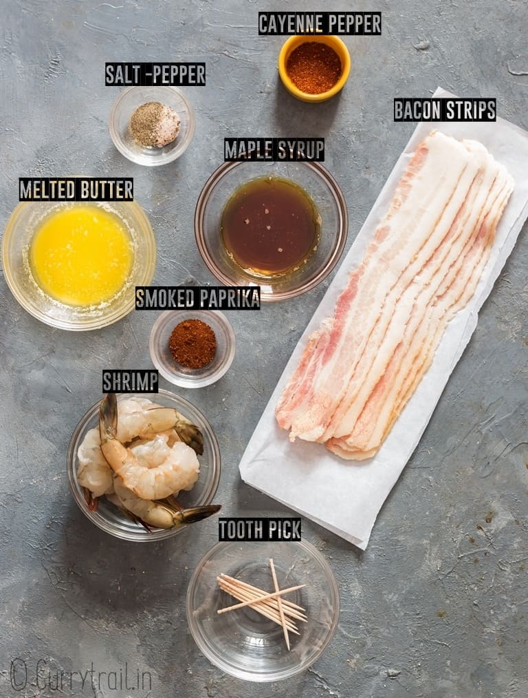 ingredients for bacon wrapped shrimp recipe lined up on grey board