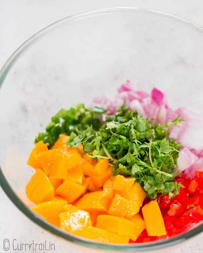 prepping mango salsa in bowl