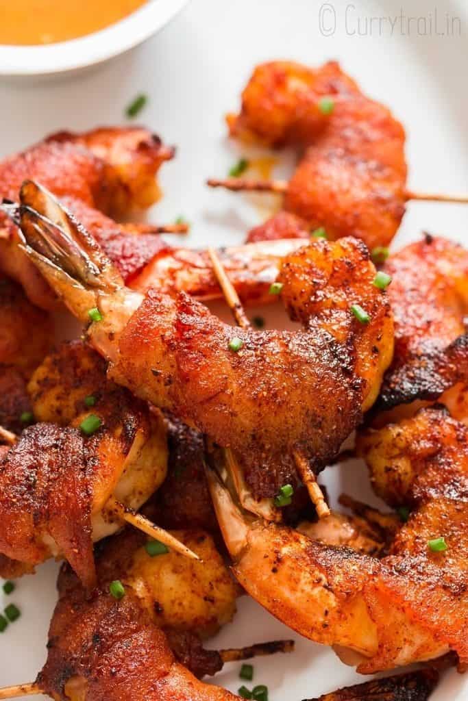 sweet-spicy oven grilled bacon wrapped shrimp on a plate