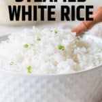 steamed rice with chives on top in white bowl with wooden spoon with text overlay