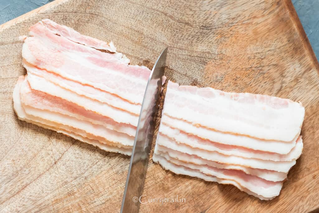 cutting bacon strips into half.