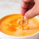 beer cheese dip made in 15 minutes served with pretzels in a white bowl with text overlay