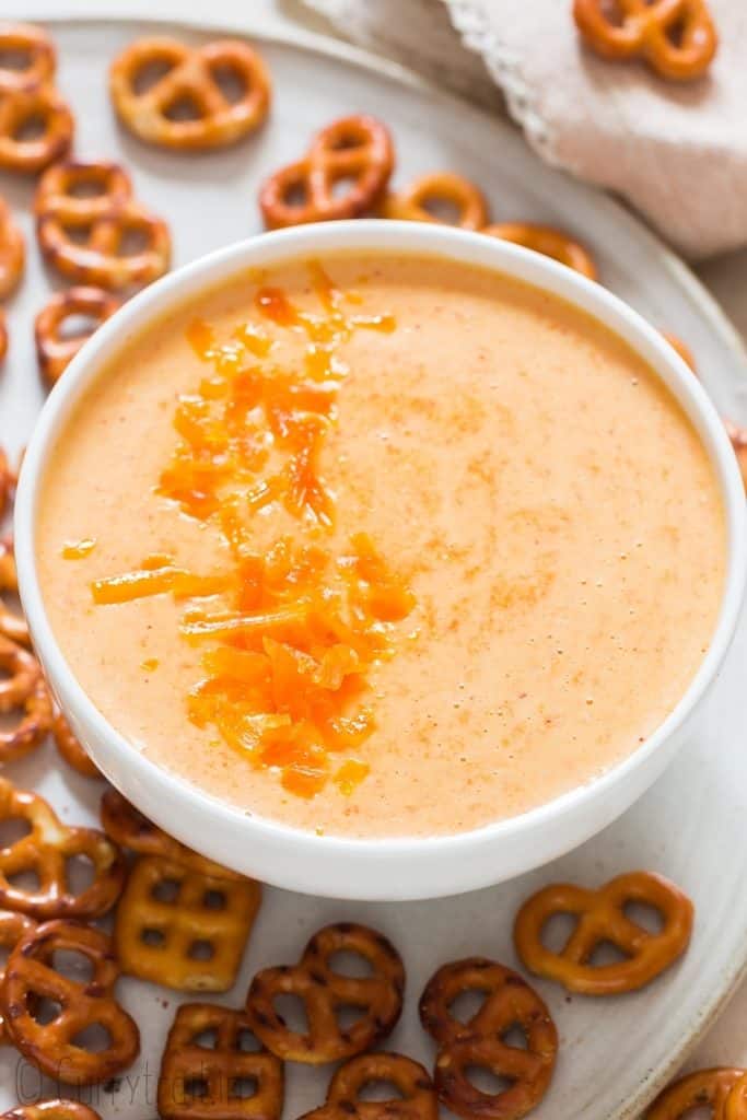 beer cheese dip and pretzels in white bowl