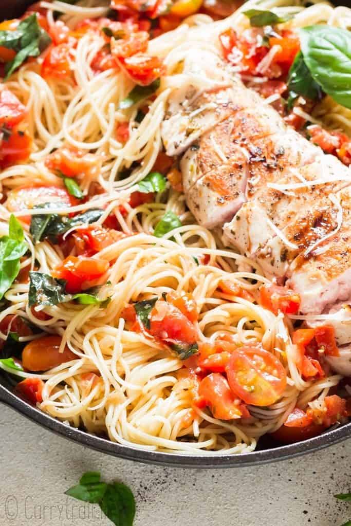 close up view of chicken pasta salad cooked in cast iron pan