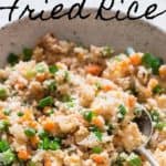 cauliflower fried rice in white bowl with text overlay