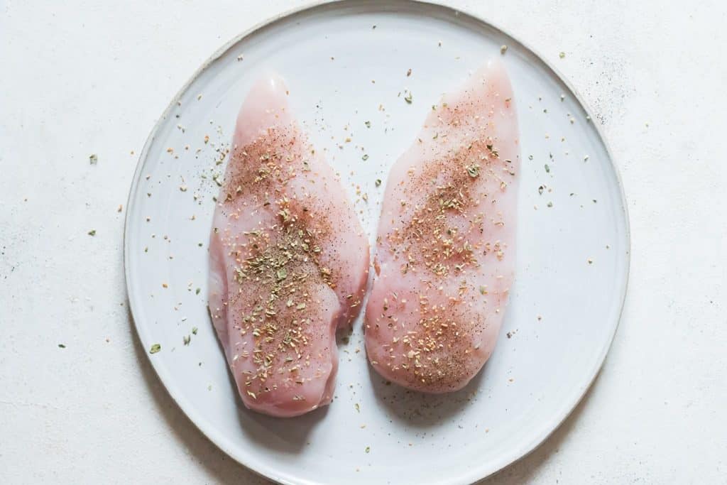 chicken breasts seasoned with salt pepper garlic and herbs