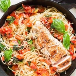 bruschetta chicken pasta in cast iron pan with napkin