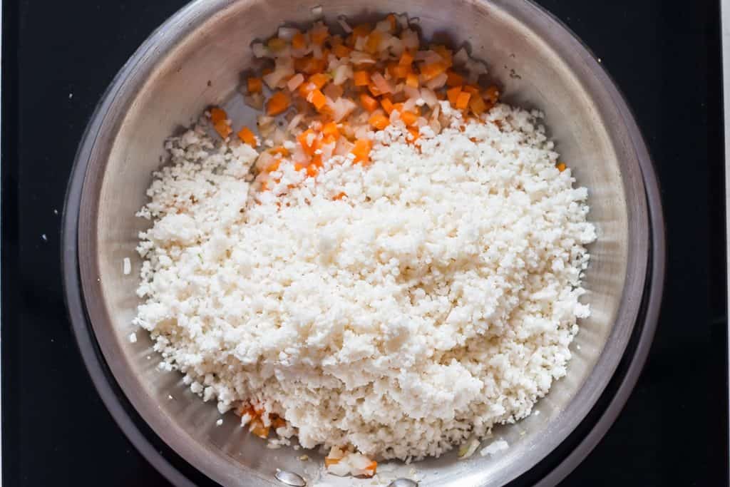 riced cauliflower cooking in a skillet