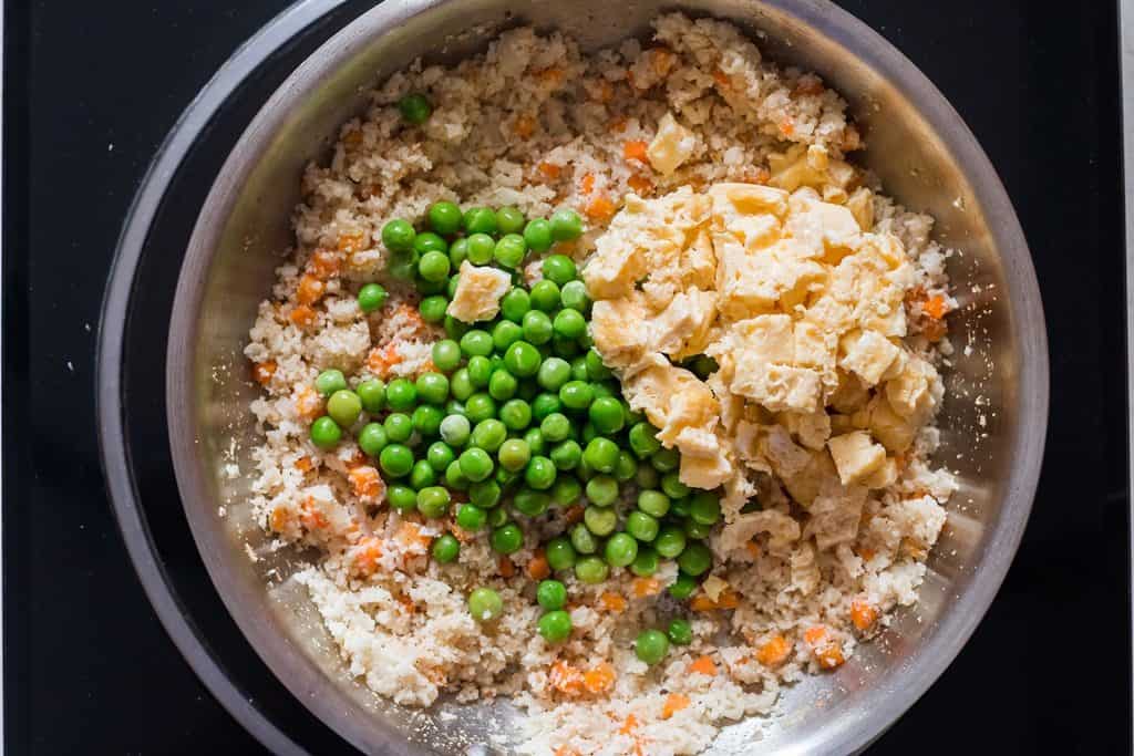 tossing cauliflower fried rice in skillet