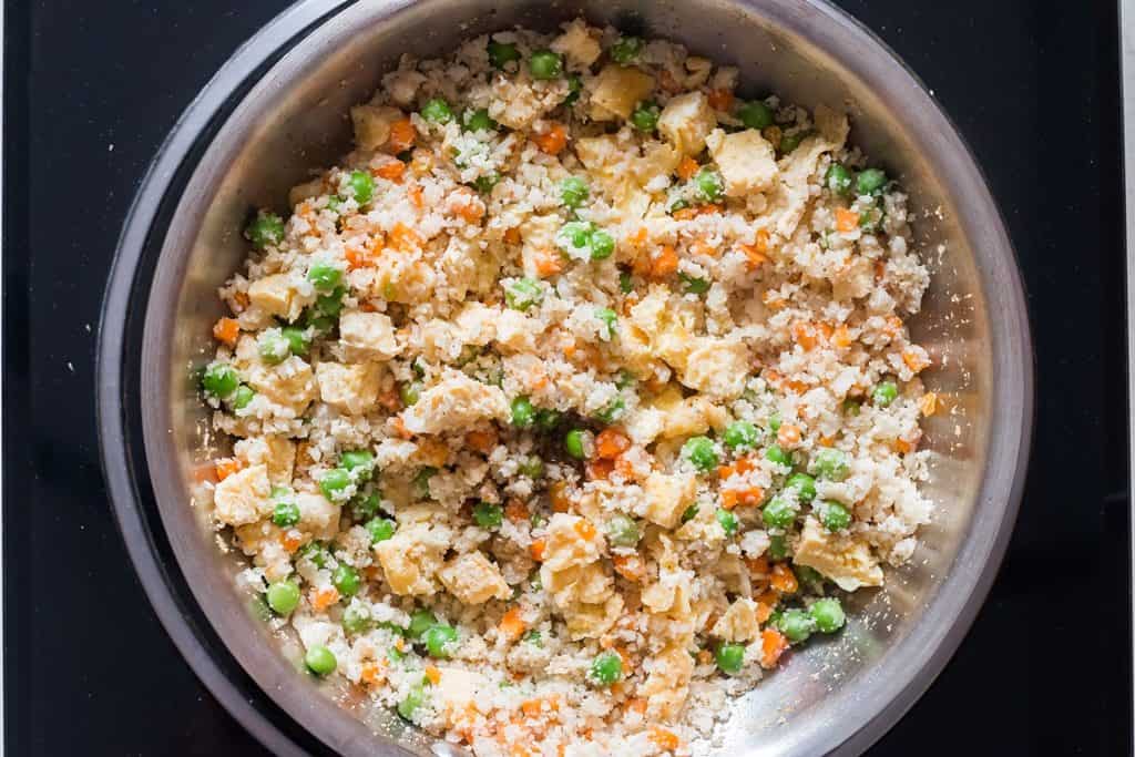 tossing cauliflower fried rice in skillet