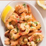 close view of lemon garlic shrimp on a plate with text.