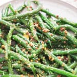 sauteed green beans with garlic and lemon with text overlay.