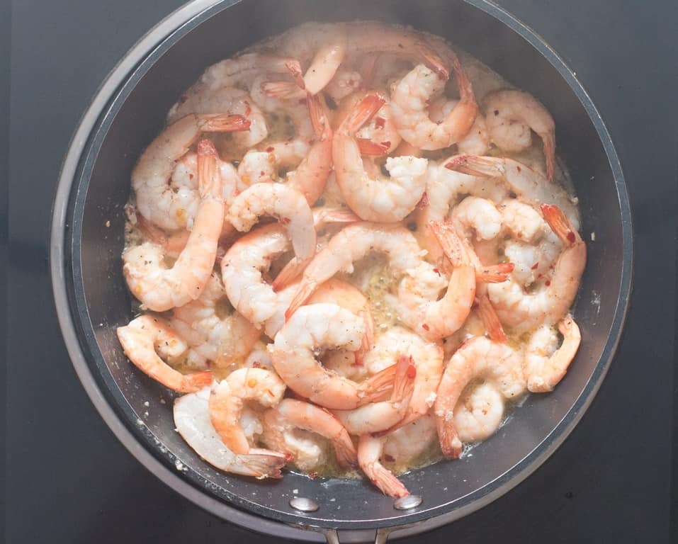 Lemon garlic shrimp cooked in a skillet.